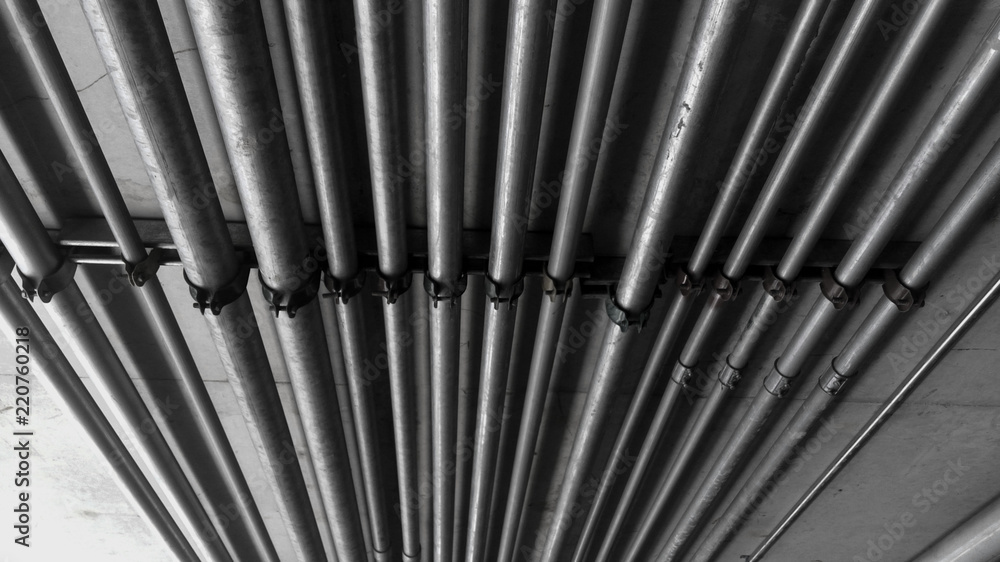 Steel pipes hanged on cement ceiling Steel pipes hanged on cement ceiling
