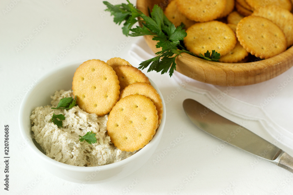 Snack from crackers and curd fish paste with herbs on a light background. Snack from crackers and curd fish paste with herbs on a light background.
