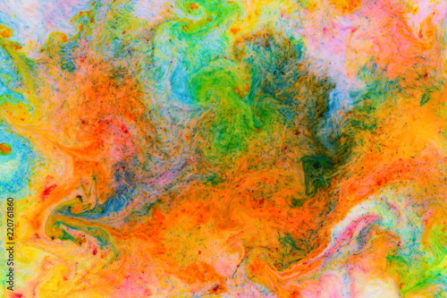 Fluid art. Abstract colorful background. Multicolored stains on liquid. Multicolored pattern with paints on liquid. Blurred background © Lazartivan