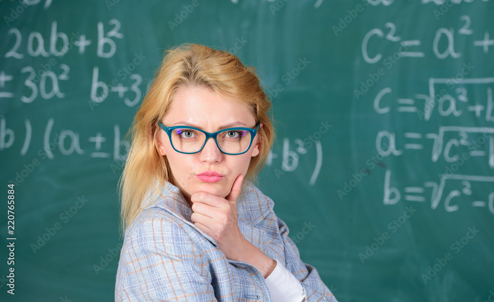 Solve mathematics task. Teacher woman think about solving and result. Lady wear eyeglasses smart teacher classroom chalkboard background, close up. Solve that task. School education basic knowledge Solve mathematics task. Teacher woman think about solving and result. Lady wear eyeglasses smart teacher classroom chalkboard background, close up. Solve that task. School education basic knowledge