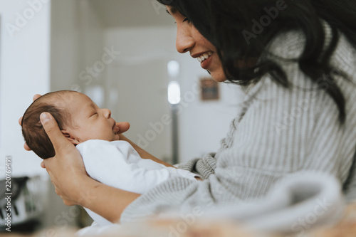 Obraz na plátně Mother holding her infant baby
