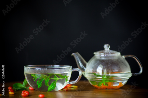 hot tea from ripe red goji berries in a glass teapot