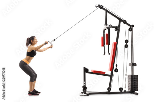 Young woman exercising on a fitness machine