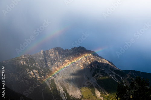 two rainbows in the Stelvio National Park, Alps, Italy