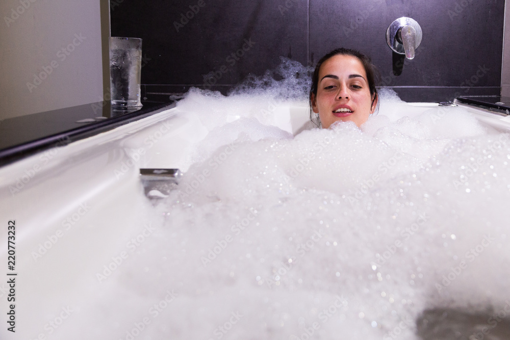 Woman taking a bath of foam