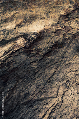 Stone texture background in beige, black and soft gold metallic.