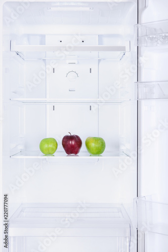 three ripe tasty apples in fridge