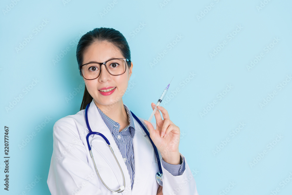 medical holding an injection and smiling friendly medical holding an injection and smiling friendly
