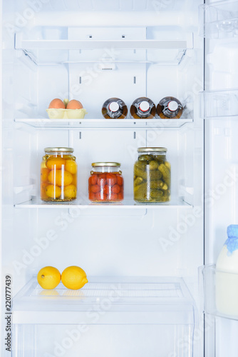 lemons, preserved vegetables and eggs in fridge