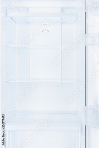 shelves in empty open white fridge