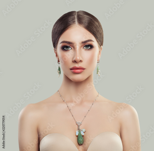 Perfect woman with fashion jewelry portrait. Jewelry for woman, necklace and earrings with pearls and green stones