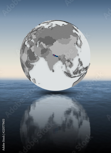 Nepal on globe above water