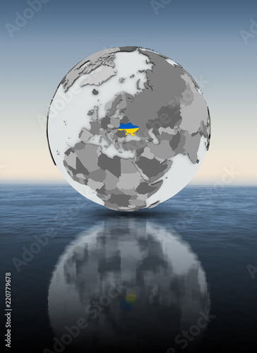 Ukraine on globe above water