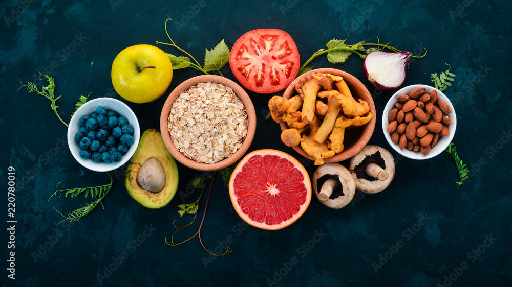 Food. Vegetables, fruits, nuts and berries. Healthy food. On the stone table. Top view. Free space for text. Food. Vegetables, fruits, nuts and berries. Healthy food. On the stone table. Top view. Free space for text.