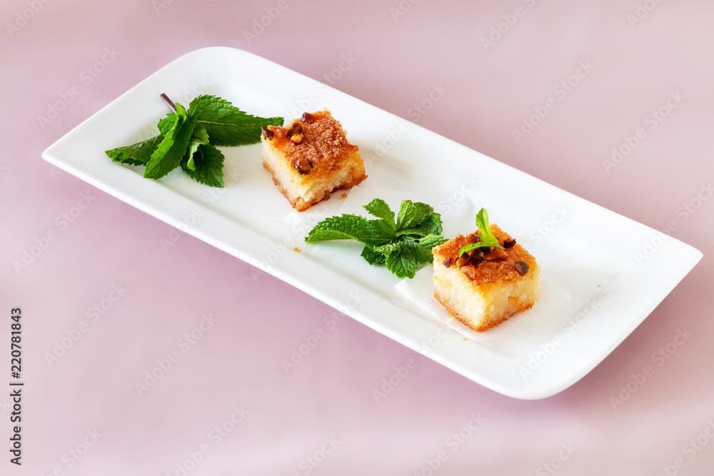 Two piecies Basbousa or Namoora traditional arabic dessert. Two piecies Basbousa or Namoora traditional arabic dessert.