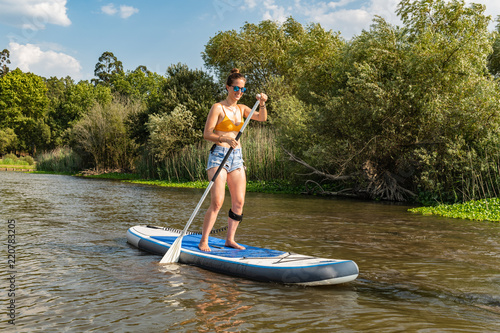 Woman stand up paddleboarding