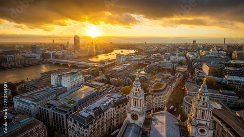 London, England - Aerial panoramic skyline view of London taken from top of St.Paul's Cathedral at sunset with River Thames, beautiful golden sky and clouds