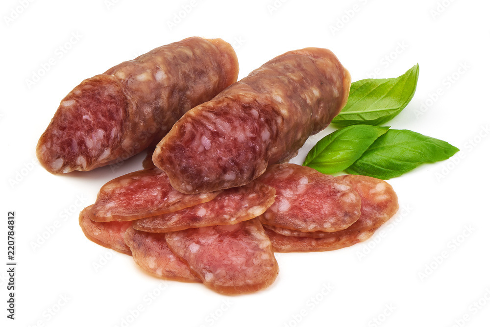 Smoked sausage with thin slices and green basil leaves, isolated on white background