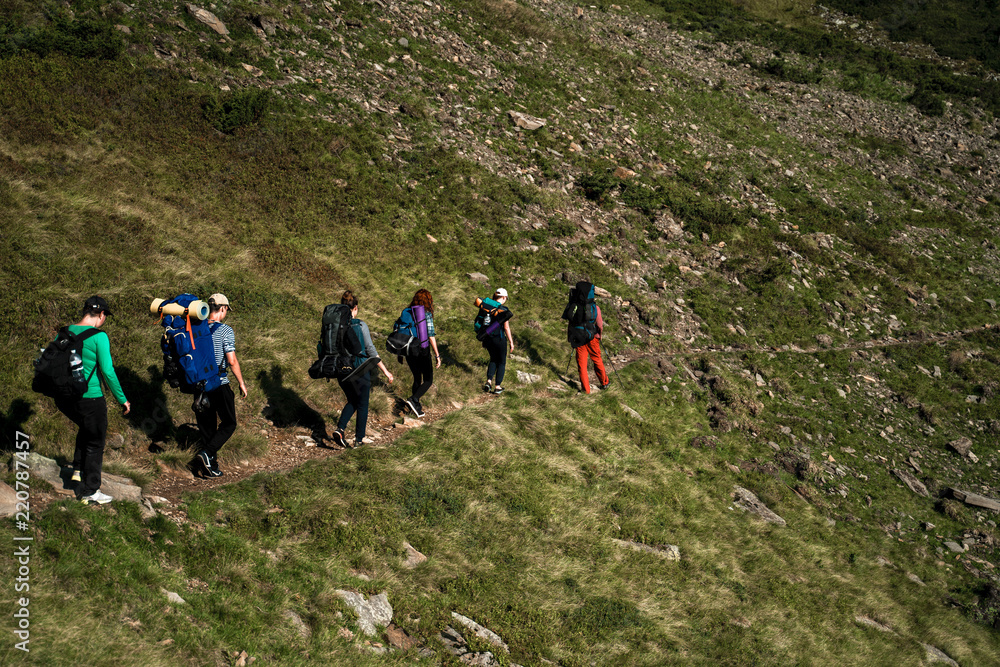 Group of hikers walking on a mountain. Carpathains, Ukraine