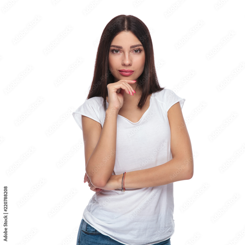 portrait of pensive casual woman in white t-shirt standing portrait of pensive casual woman in white t-shirt standing