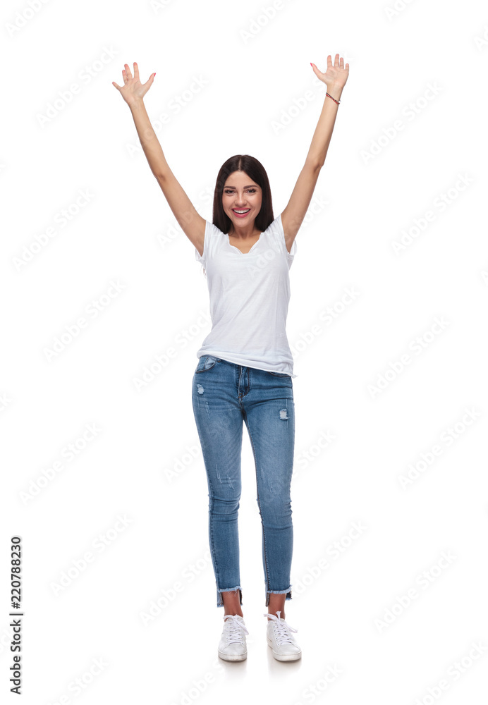 pretty casual woman celebrating with hands in the air pretty casual woman celebrating with hands in the air