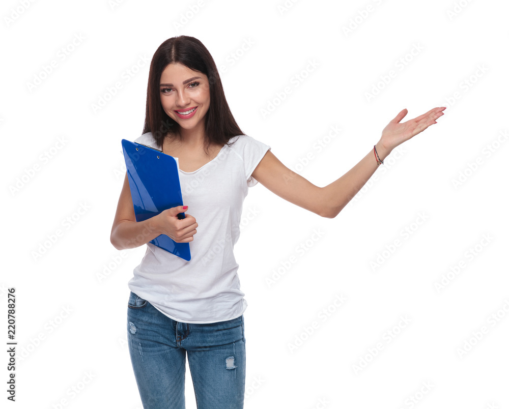 beautiful casual woman holds blue folder and presents to side beautiful casual woman holds blue folder and presents to side