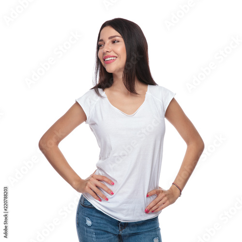 portrait of confident woman in white t-shirt looking to side © Viorel Sima