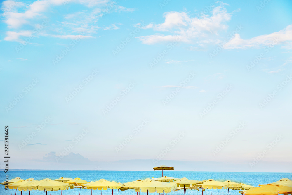 Beach with yellow umbrellas. Landscape of the sea Beach with yellow umbrellas. Landscape of the sea