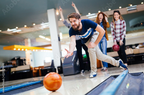 Friends having fun while bowling photo