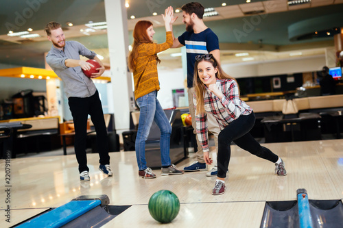 Friends having fun while bowling