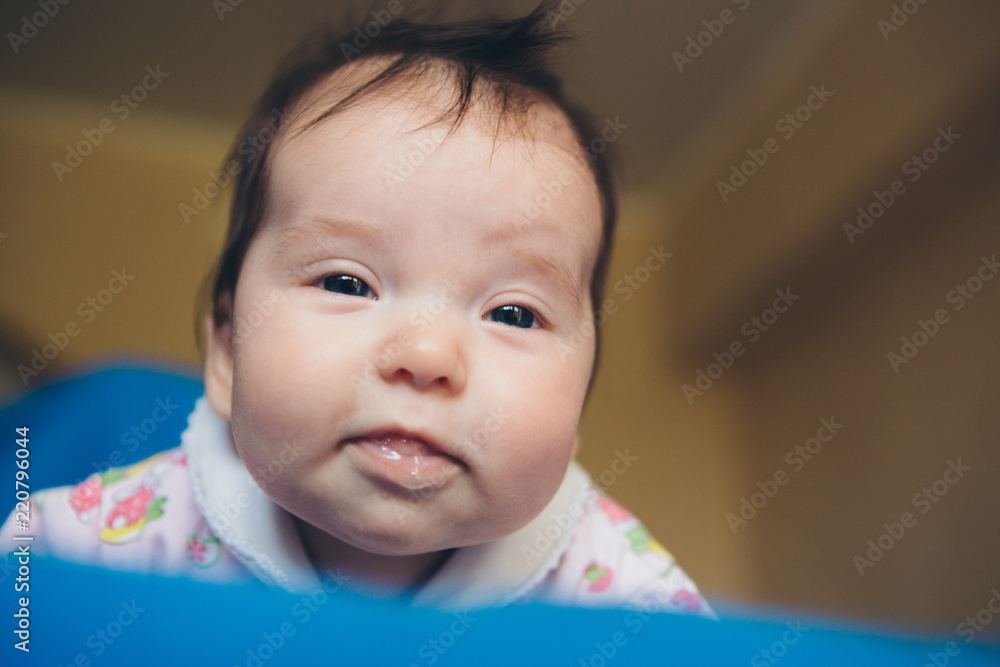 newborn baby lying on his stomach with saliva in his mouth newborn baby lying on his stomach with saliva in his mouth