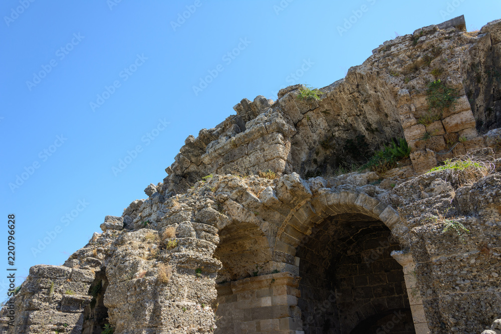 ruins of the ancient amphitheater with arched niches of the lower floors. Side, Turkey