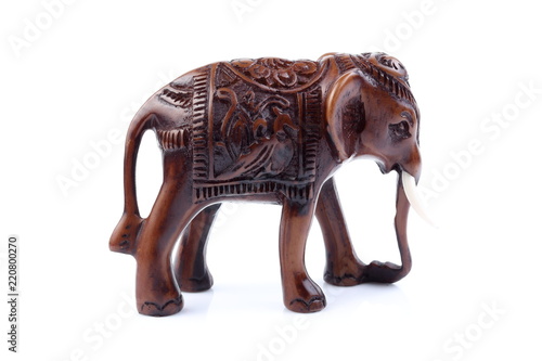 Brown Engraved pattern elephant like wooden carving with white ivory. Stand on white background  Isolated  Art Model Thai Crafts  For decoration Like in the spa.