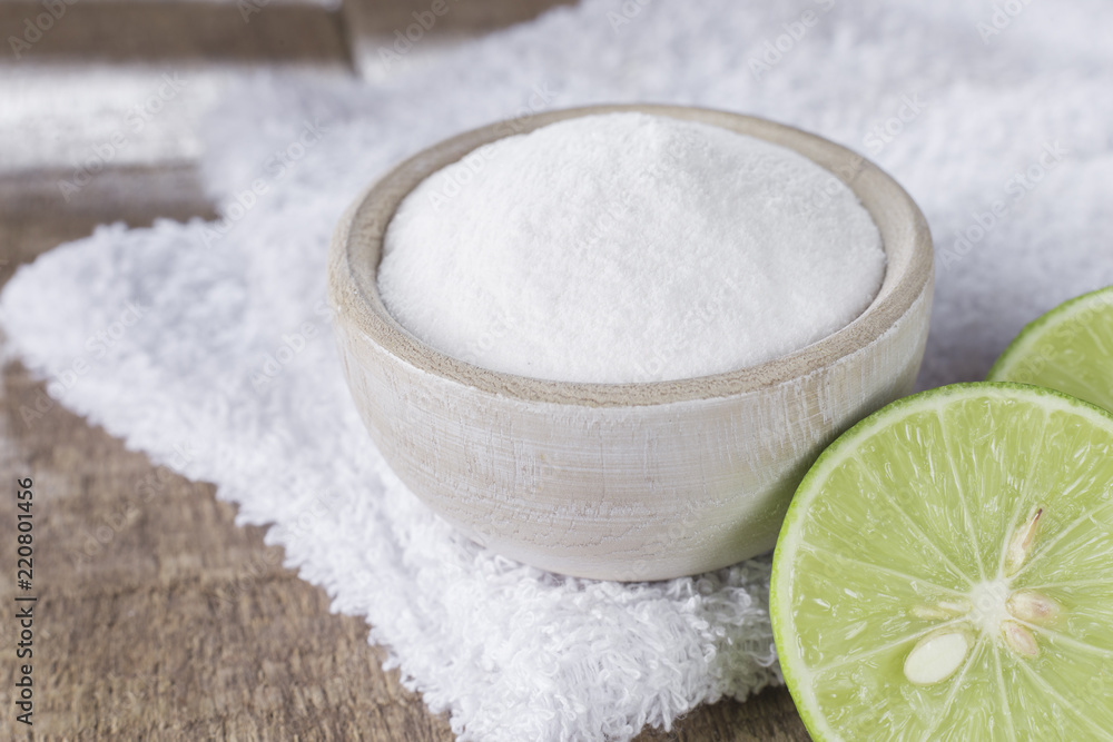 baking soda and lemon on wooden table baking soda and lemon on wooden table