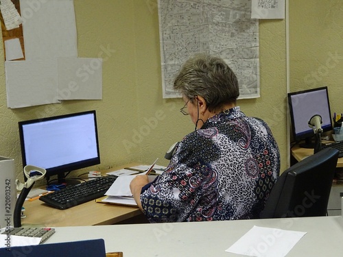 Post postage mail office operator secretary woman working type typing and register registering information on the computer photo