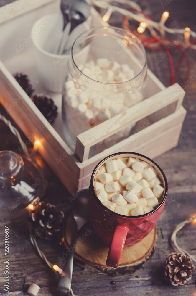 hot cocoa with marshmallows on wooden table with christmas lights. Cozy winter home concept hot cocoa with marshmallows on wooden table with christmas lights. Cozy winter home concept