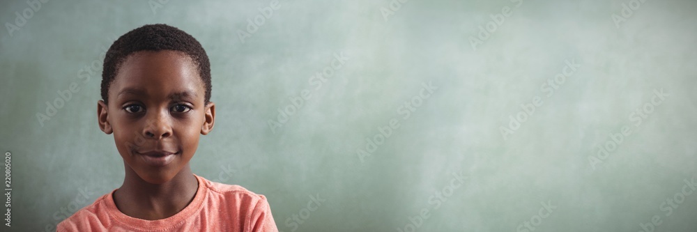 Smiling boy against blank greenboard Smiling boy against blank greenboard