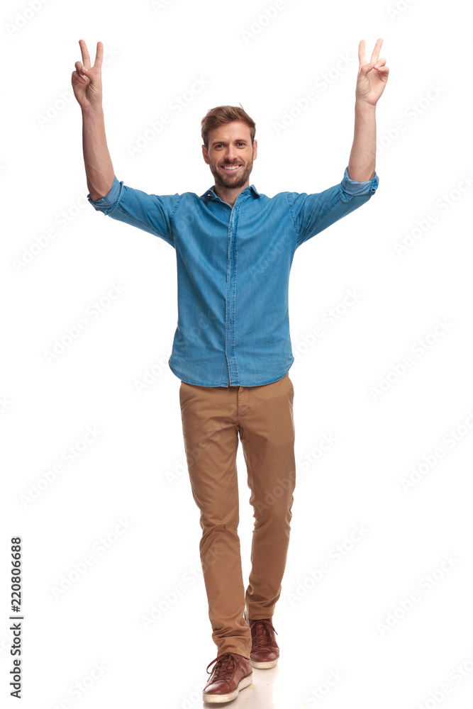 smiling casual man with hands in the air celebrating victory smiling casual man with hands in the air celebrating victory