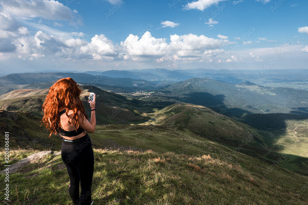Tourist is taking photo of amazing view on cell phone. Carpathians, Ukraine Tourist is taking photo of amazing view on cell phone. Carpathians, Ukraine