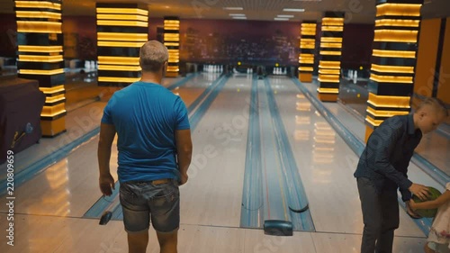 Friends bowling at club and having fun playing casually