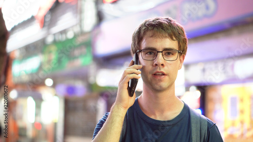 Young Man Calling On Mobile Phone at Night