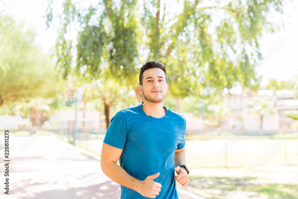 Ambitious Runner Working Out In Park During Summer Ambitious Runner Working Out In Park During Summer