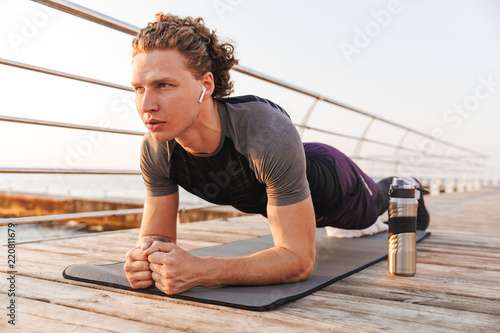 Portrait of a confident sportsman doing plank exercise
