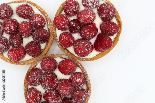 Wallpaper Mural Three tartlets with raspberry on white background Torontodigital.ca
