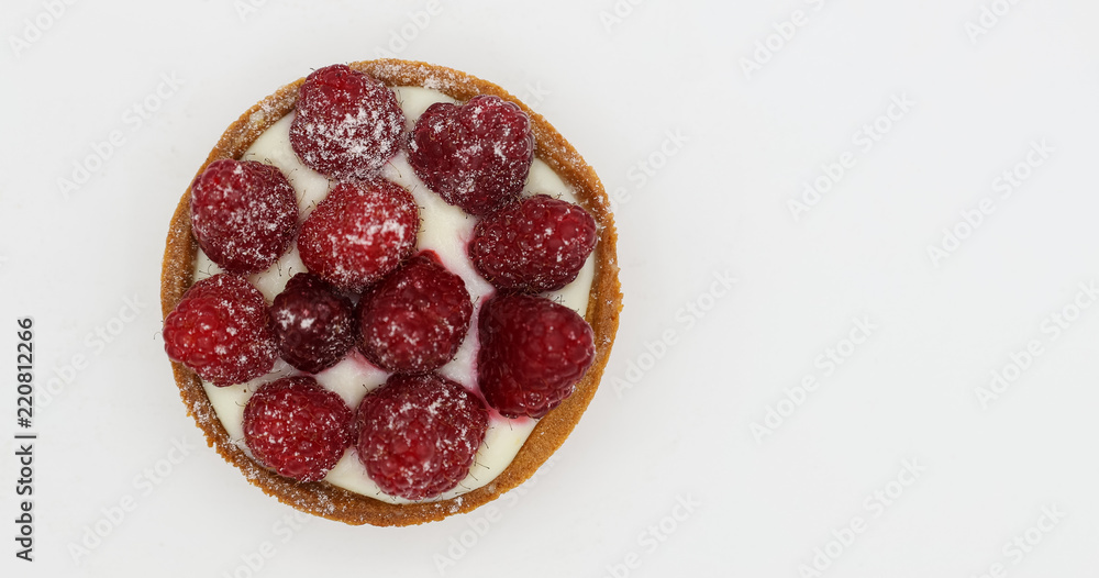 Tartlet with raspberry on white background Tartlet with raspberry on white background