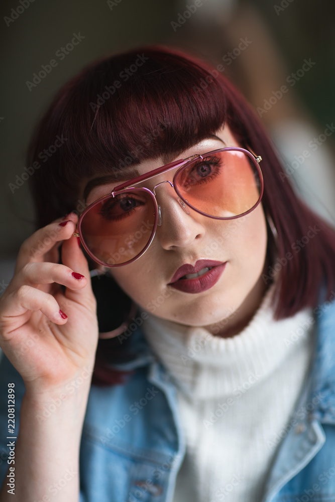 Portrait of young redhead with denim jacket turtle neck and glasses Portrait of young redhead with denim jacket turtle neck and glasses