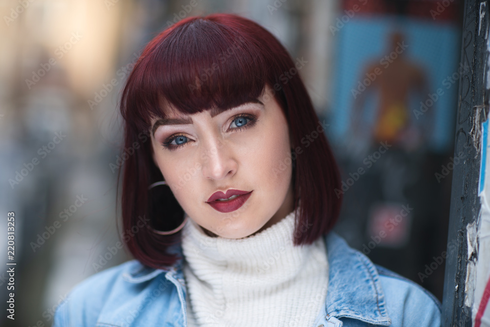 Portrait of young redhead with denim jacket and white turtle neck Portrait of young redhead with denim jacket and white turtle neck