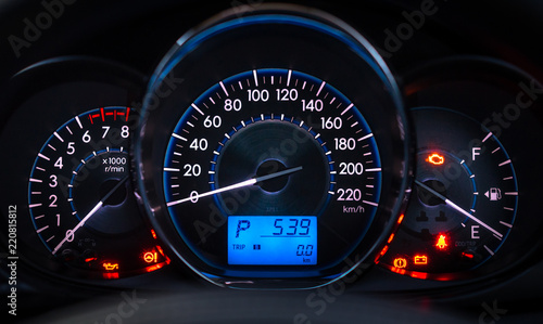 car meter with white and blue light at dark background photo