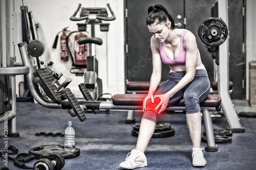 Composite image of healthy woman with an injured knee sitting in