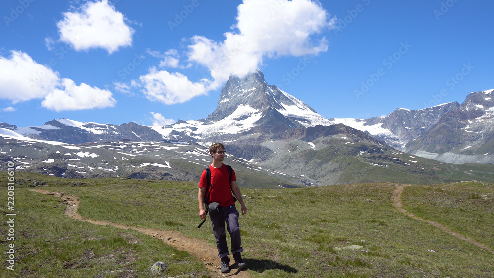 Young Caucasian Man With Backpack Hiking in Mountains